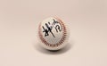 Closeup shot of a baseball signed by a former Cuban player