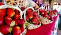 Closeup shot of a basket of tasty strawberries in a market