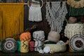 Closeup shot of baskets full of multicolored knitting wool balls and macrame hanging on the wall Royalty Free Stock Photo