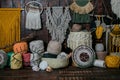 Closeup shot of baskets full of multicolored knitting wool balls and macrame hanging on the wall Royalty Free Stock Photo