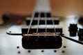 Closeup shot of a bass guitar bridge - Fender Jazz Bass style bridge. Royalty Free Stock Photo