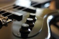 Closeup shot of a bass guitar bridge - Fender Jazz Bass style bridge Royalty Free Stock Photo