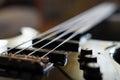 Closeup shot of a bass guitar bridge - Fender Jazz Bass style bridge Royalty Free Stock Photo