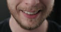 Closeup shot of bearded man mouth smile