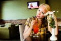 Closeup shot of a beautiful blonde woman having a cocktail looking at camera thoughtfully. Copyspace on the side Royalty Free Stock Photo