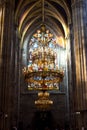 Closeup shot of the beautiful chandelier in front of stained glass window in Votive Church, Vienna