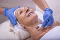 Closeup shot of a beautiful female in beauty salon during mesotherapy procedure with derma roller Royalty Free Stock Photo