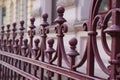 Closeup shot of the beautiful metal fences in front of a stone building Royalty Free Stock Photo