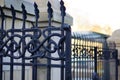 Closeup shot of the beautiful patterned details of an iron fence Royalty Free Stock Photo