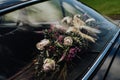 Closeup shot of the beautiful wedding bouquet in the car Royalty Free Stock Photo