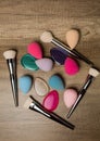 Closeup shot of beauty blenders, silicone sponges and makeup brushes on a wood background. Space for text Royalty Free Stock Photo