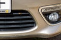 Closeup shot of a bee sitting on a bumper of a modern car