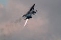 Closeup shot of the Belgian F16 demo afterburning with heavy clouds Royalty Free Stock Photo