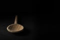 Closeup shot of a big wooden spoon isolated on black background Royalty Free Stock Photo