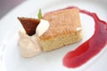 Closeup shot of a biscuit with vanilla ice cream decorated with a strawberry jam Royalty Free Stock Photo