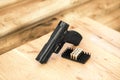 Closeup shot of the black handgun and the bullets on the wood Royalty Free Stock Photo