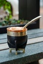 Closeup shot of a black mate cup with mate bombilla straw.