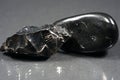 Closeup shot of black obsidian stones isolated on gray background