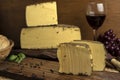 Closeup shot of blocks of gourmet Beaufort cheese and a glass of wine