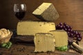 Closeup shot of blocks of gourmet Beaufort cheese and a glass of wine