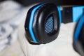 Closeup shot of a blue and black headset placed on a white cloth