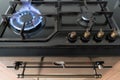 Closeup shot of blue fire from domestic kitchen hob. Gas cooker with burning flames propane gas. Royalty Free Stock Photo