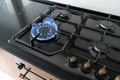 Closeup shot of blue fire from domestic kitchen hob. Gas cooker with burning flames propane gas. Royalty Free Stock Photo