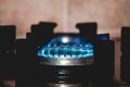 Closeup shot of blue fire from domestic kitchen stove top. Gas cooker with burning flames. Industrial resources and economy Royalty Free Stock Photo