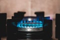 Closeup shot of blue fire from domestic kitchen stove top. Gas cooker with burning flames. Industrial resources and economy Royalty Free Stock Photo