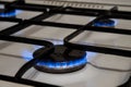 Closeup shot of blue fire from domestic kitchen stove top. Gas cooker with burning flames of propane gas Royalty Free Stock Photo