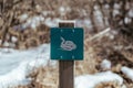 Closeup shot of a blue sign of a white snake attached to a wood Royalty Free Stock Photo