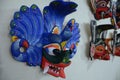 Closeup shot of a blue traditional Sri Lankan mask Maura Raksha hanging on a white wall Royalty Free Stock Photo