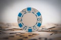 Closeup shot of a blue-white poker chip on the blurred background Royalty Free Stock Photo