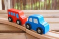 Closeup shot of blue wooden toy car red wooden toy bus on a wooden track Royalty Free Stock Photo