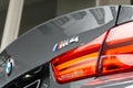 Closeup shot of a BMW M4 with a gray "M4" logo