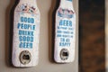 Closeup shot of bottle openers with funny beer quotes