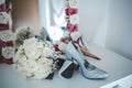 Closeup shot of a bouquet and sparkly shoes on a vanity