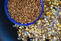 Closeup shot of a bowl of buckwheat and grains isolated on dark surface