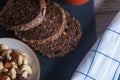 Closeup shot of a bowl of cashews next to the rye bread