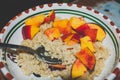 Closeup shot of a bowl of oats and peach