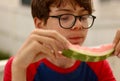 Closeup shot of a boy eating a slice of watermelon Royalty Free Stock Photo