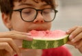 Closeup shot of a boy eating a slice of watermelon Royalty Free Stock Photo