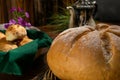 Closeup shot of bread with a flower cut from the top beside a bread bowl