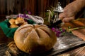 Closeup shot of bread with a flower cut from the top beside a bread bowl