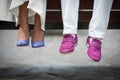 Closeup shot of bride and groom shoes: blue and purle closeup