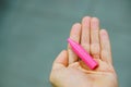 Closeup shot of a broken pink crayon on a hand