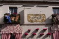 Closeup shot of building wall with balconies, flowers and curtains in street in Cordoba city, Spain