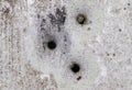 Closeup shot of bullet holes on an old rusted street sign