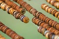 Closeup shot of a bunch of different metallic bottle caps on ropes