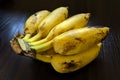 Closeup shot of a bunch of ripe bananas on a dark surface Royalty Free Stock Photo